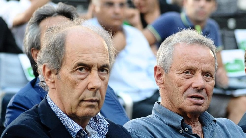 Foschi and Zamparini sit in the stands watching a performance
